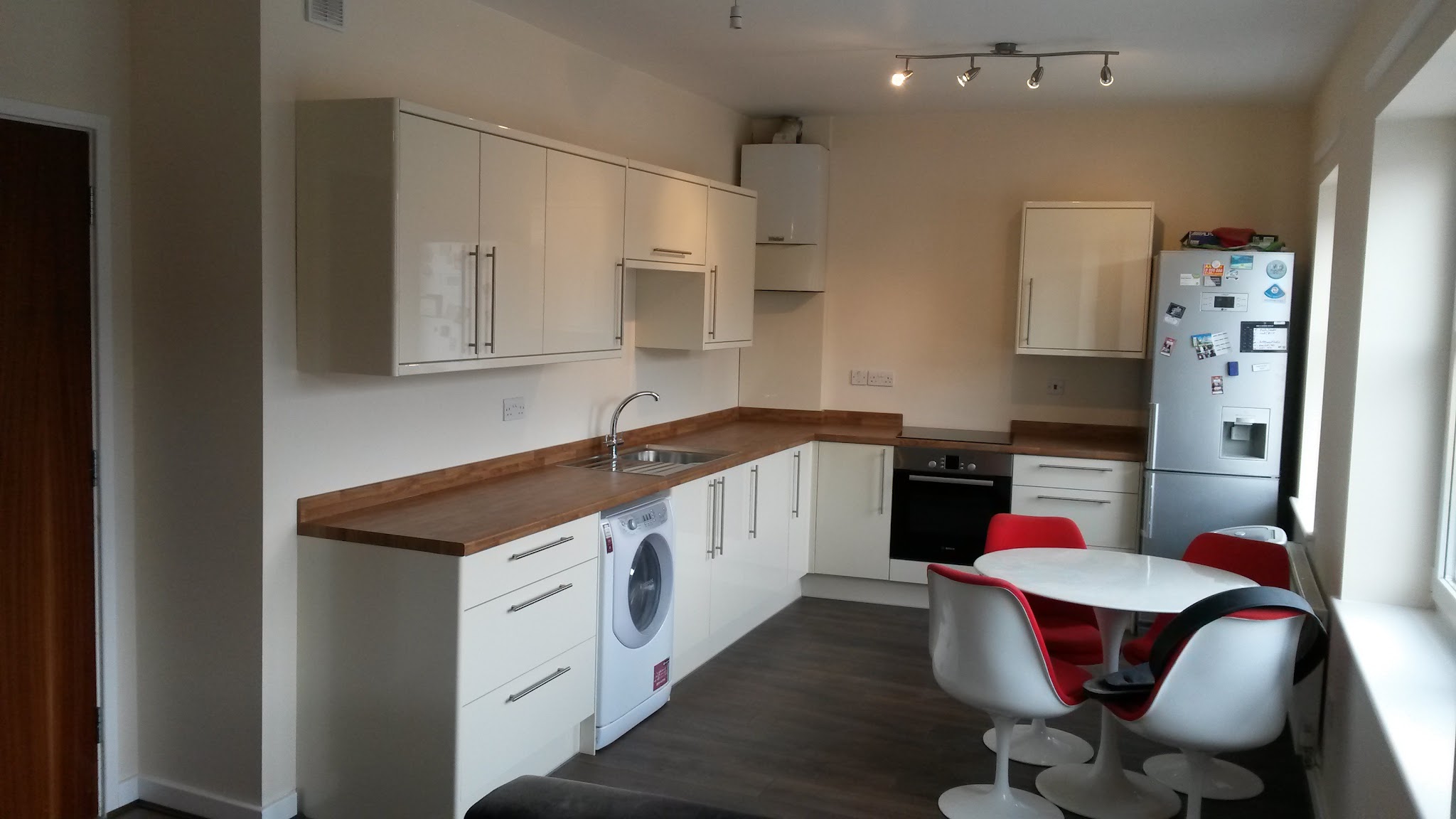 Gloss white kitchen with wood worktops